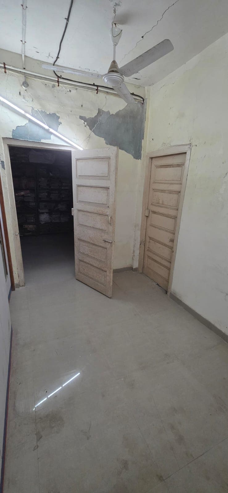 A branch space mid-handover, fixtures cleared for transport